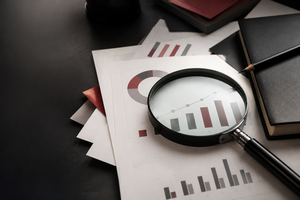 Magnifying glass over business reports and charts